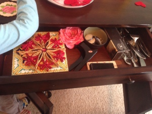 Dining room hutch drawer: Removed some small serving dishes I have NEVER used, and napkin rings we registered for but have NEVER used. Made room for trivets that have been cluttering the bottom of the hutch. Should probably get rid of the trivets, too, but I may have to convince myself of that later. (Also, toddler arm photobomb!)